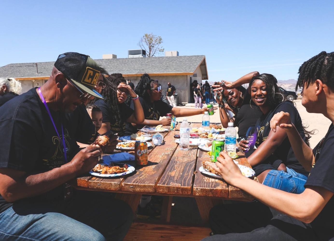 Members of The Sanctuary Church sharing a meal together at an outdoor community gathering.