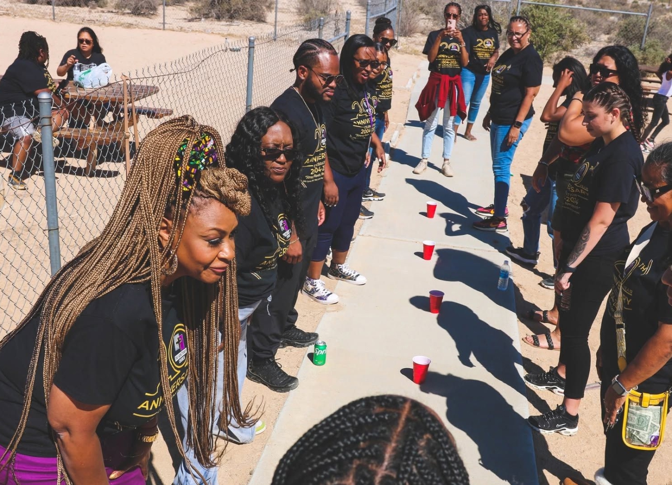 Members of The Sanctuary Church gathered outdoors during a community event.