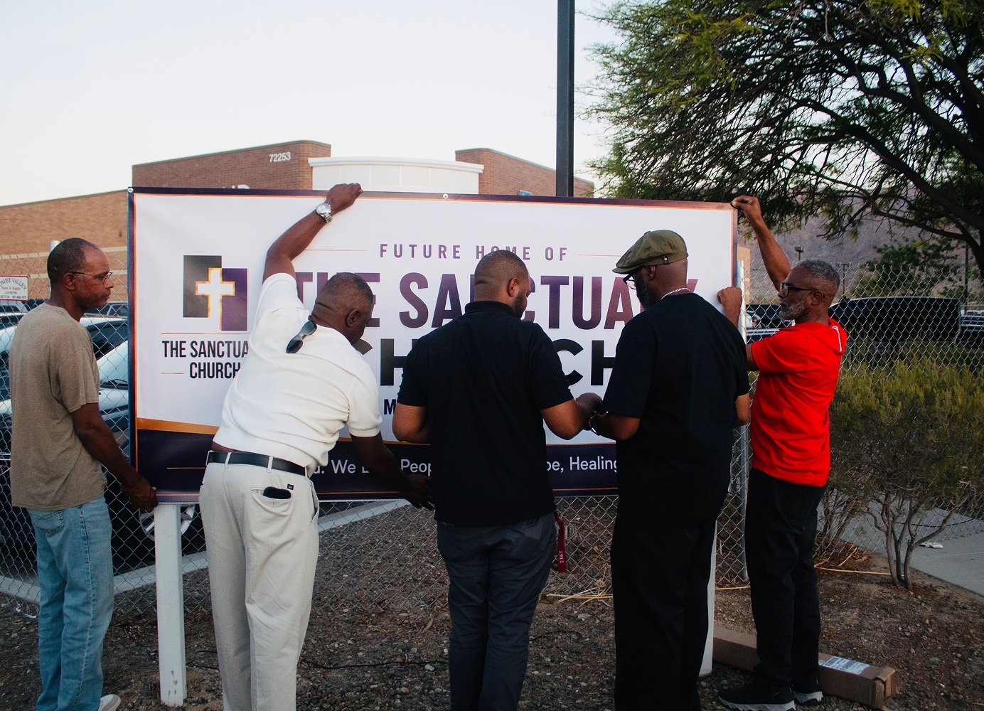 Members of The Sanctuary Church installing a sign for the church’s future location.