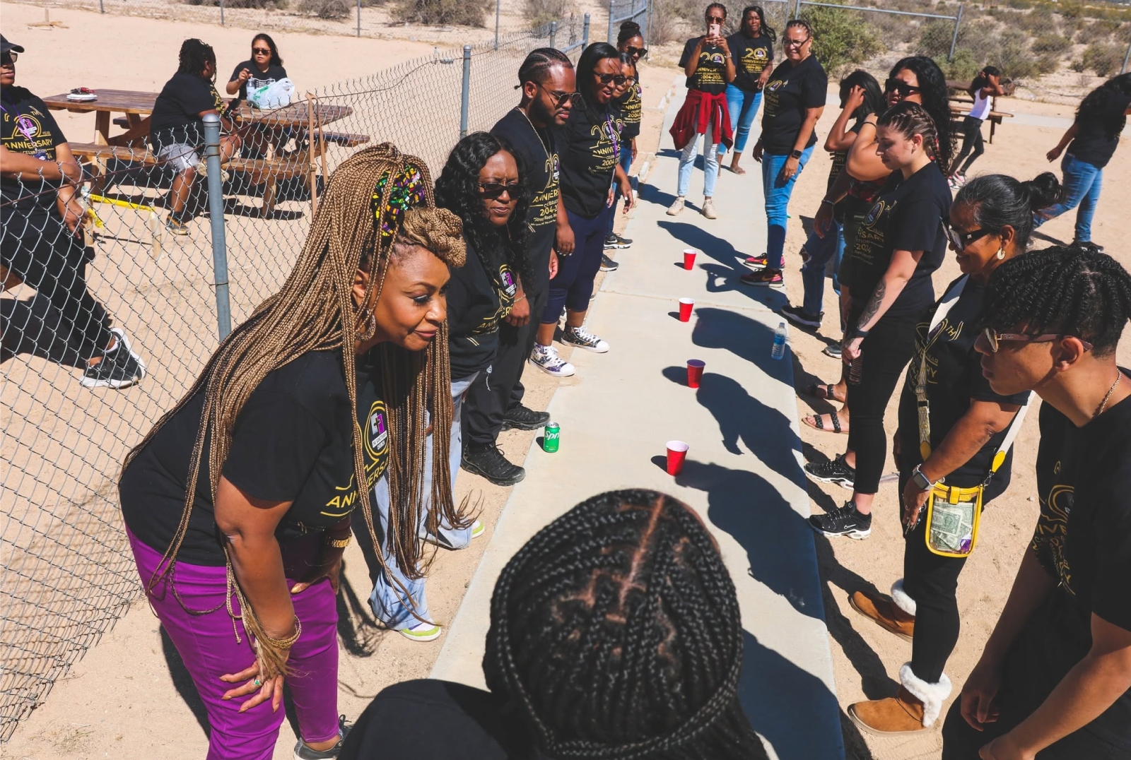 Members of The Sanctuary Church gathered outdoors during a community event.