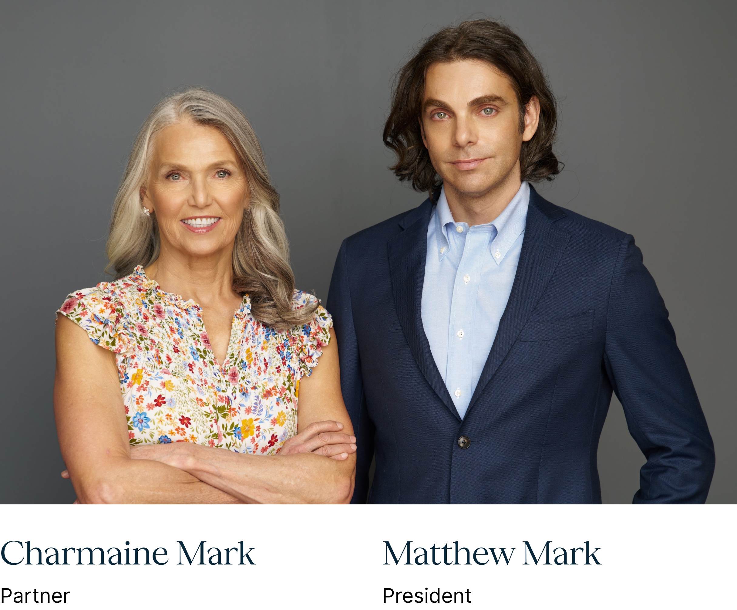 Charmaine Mark and Matthew Mark posing together against a gray studio background.