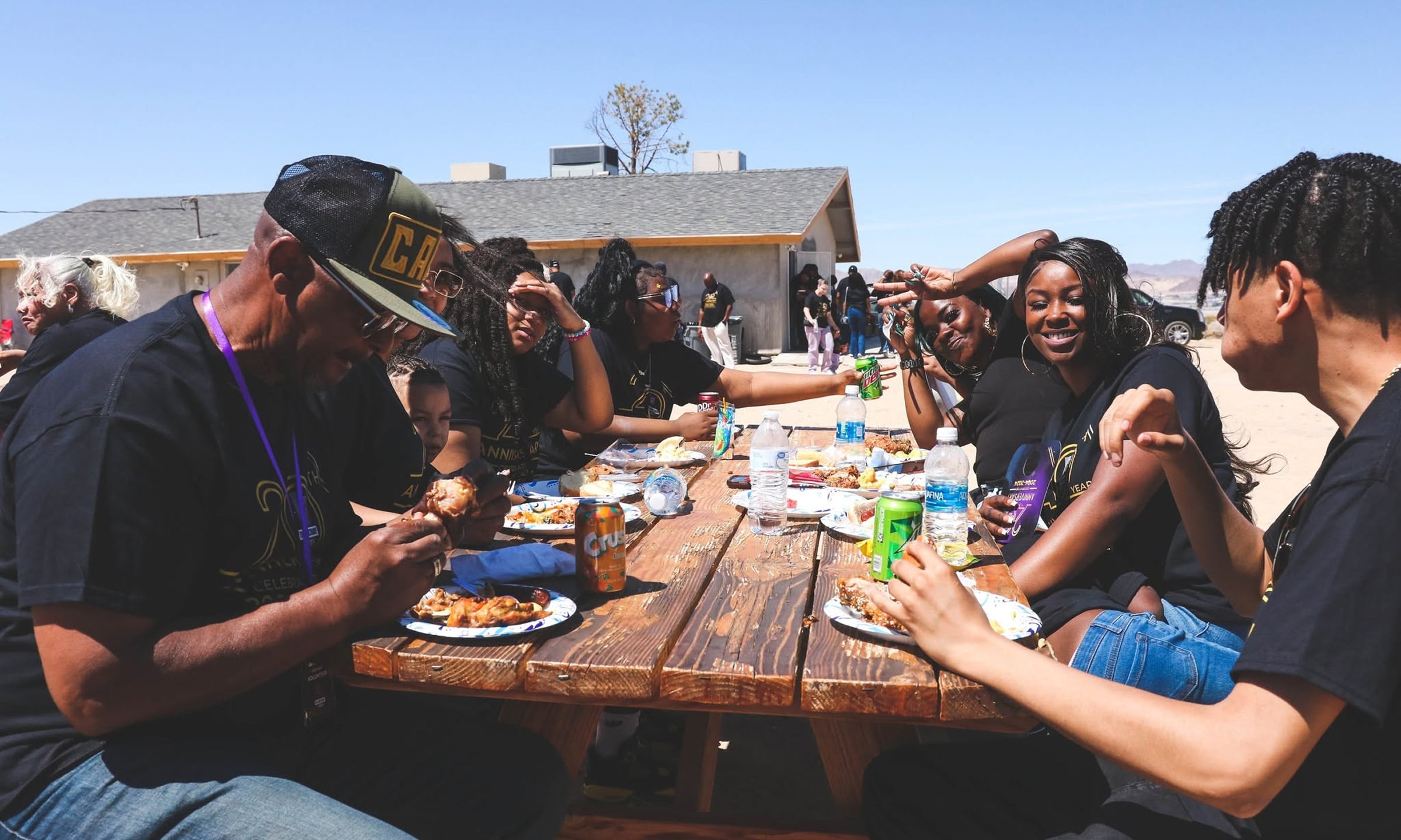 Members of The Sanctuary Church sharing a meal together at an outdoor community gathering.